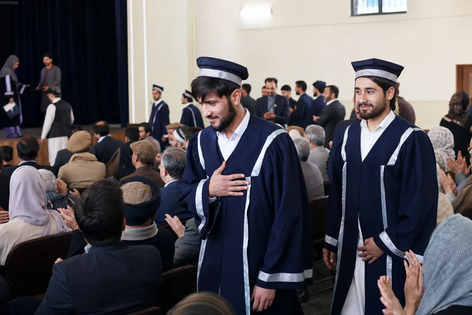 Graduates returning to their seats during the Class of 2026 ceremony